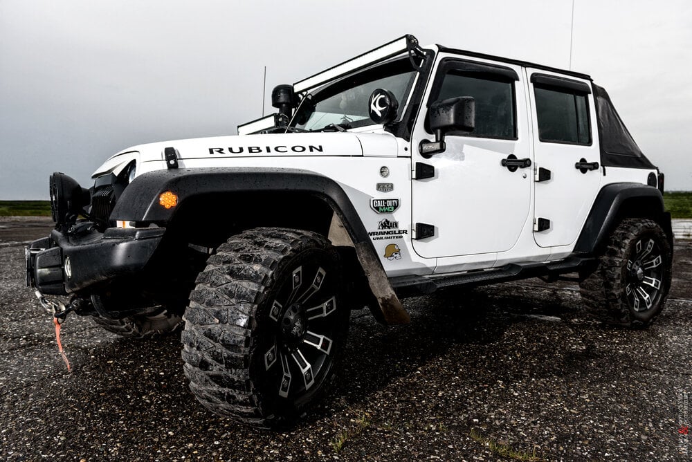 Jeep Rubicon Wrangler in the rain at dusk.