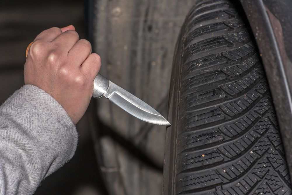 Attempting to slash a tire.