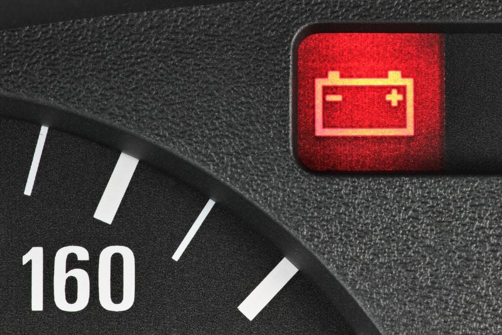 Car battery warning light on car dashboard.