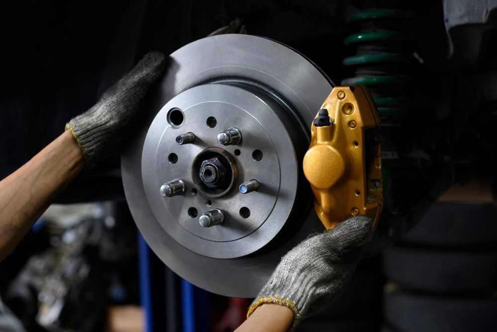 A brake rotor with a yellow brake caliper.