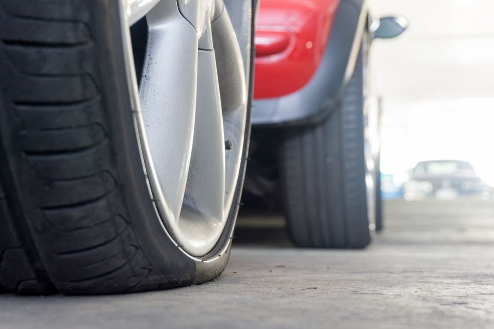 A car tire with a low tire pressure.