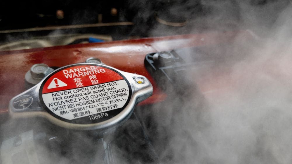 Caution: never remove the radiator cap while the engine is hot. Severe burns could result.