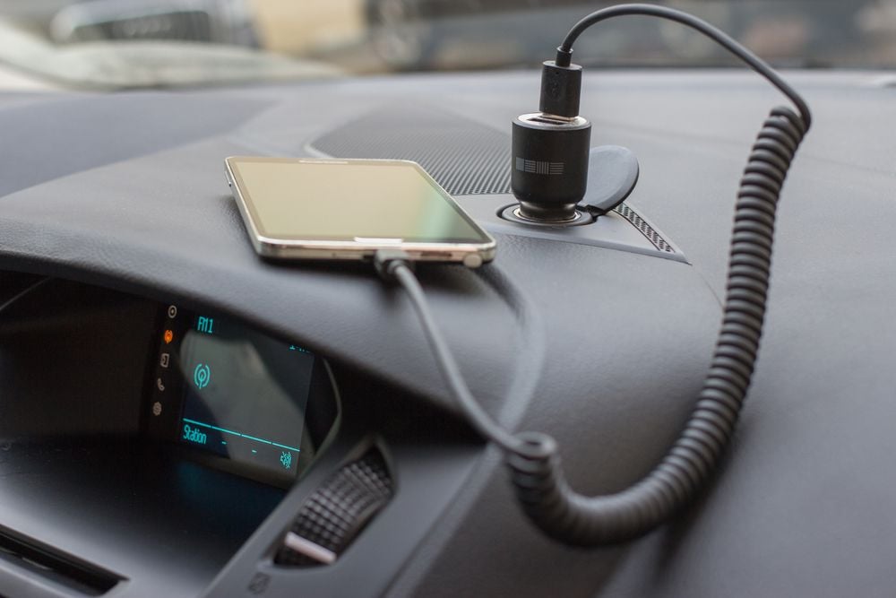 Charging a phone in a car.