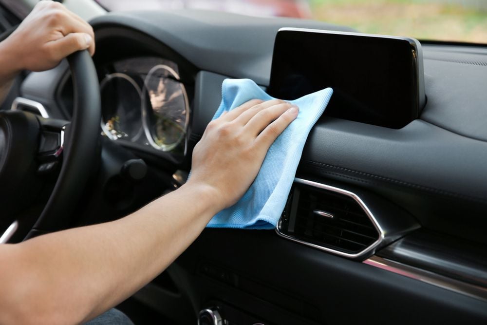 Cleaning the dash of a car.