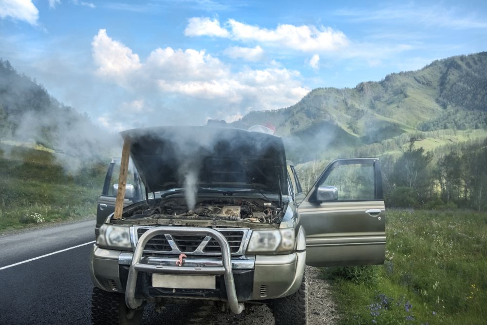 An engine with a check engine light blinking and engine overheating.