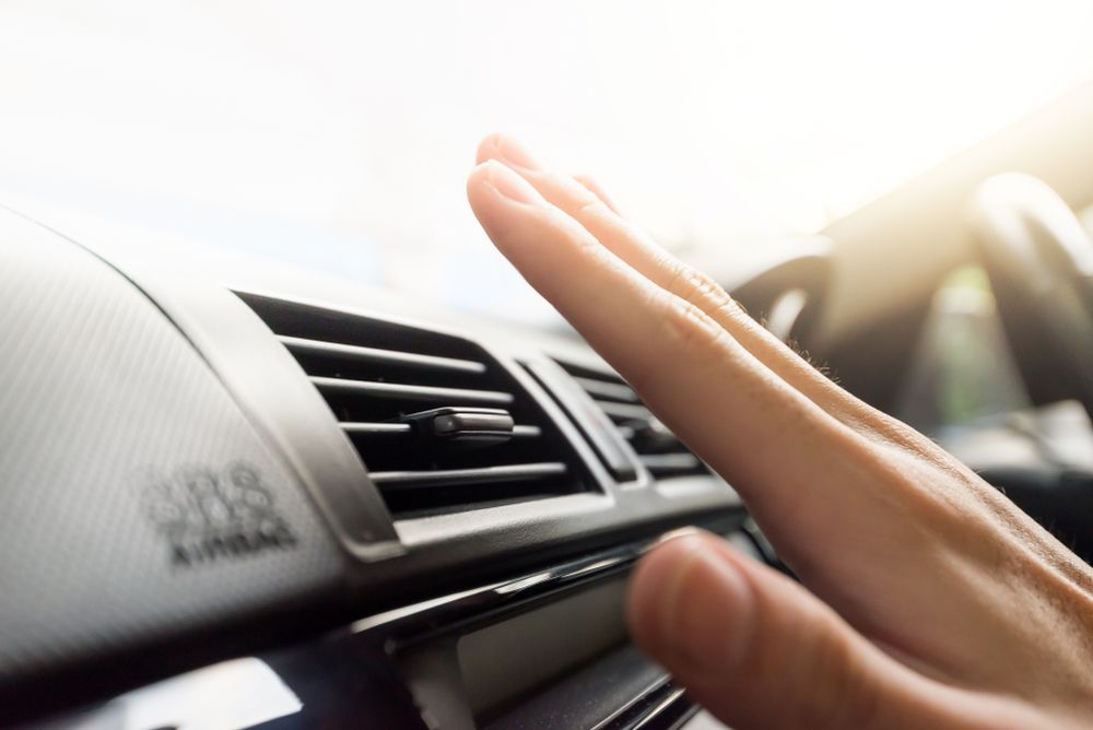 Feeling the cold air from the the car's AC vent.