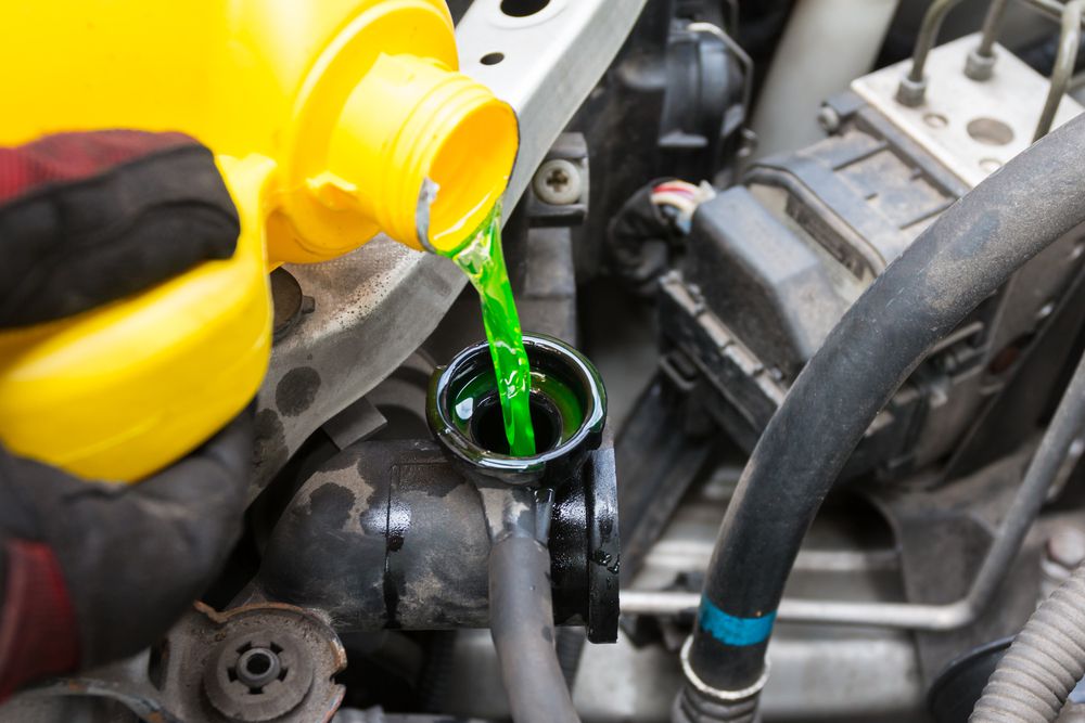 Filling a radiator with coolant.