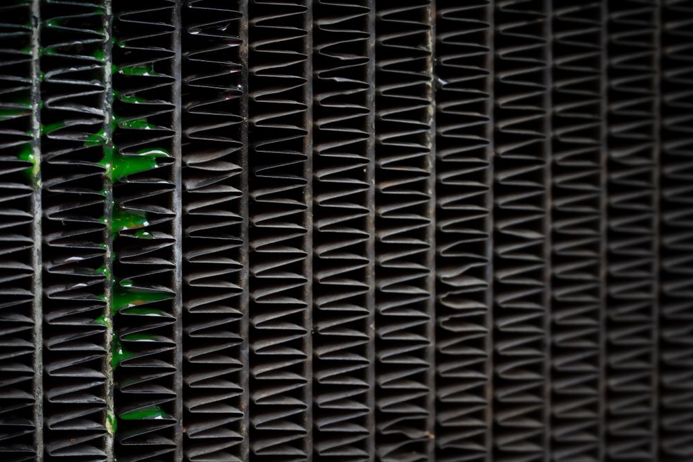 Green coolant leaking out of a radiator