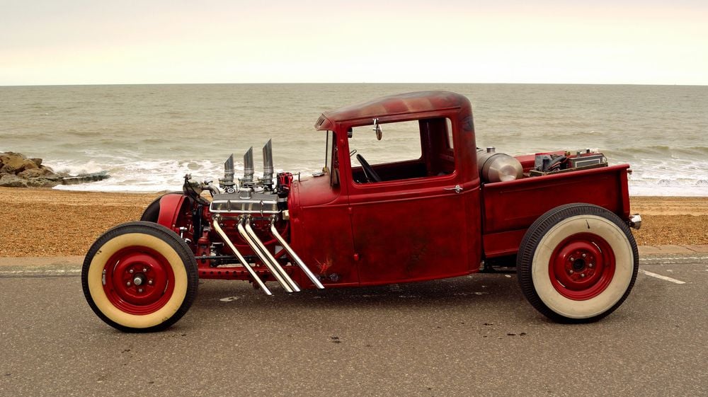A hot rod with straight pipes off the engine