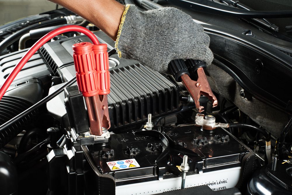 Jumper cables hooked up to a battery - black clamp on negative and the red clamp on the positive post.