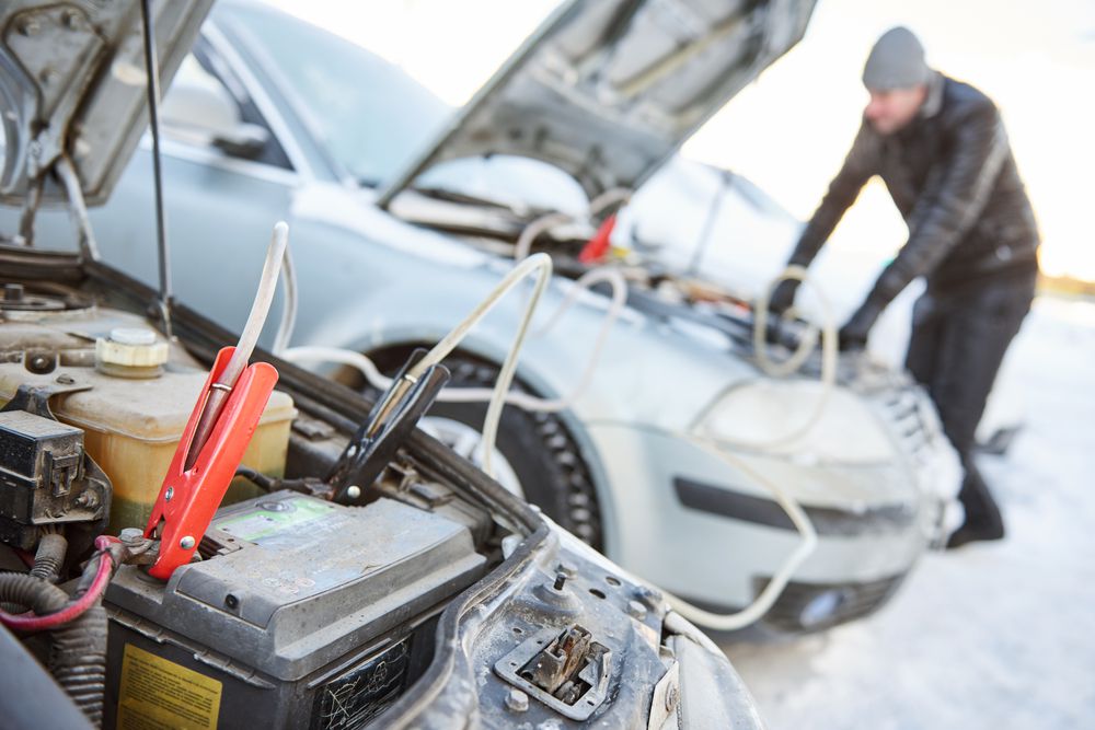 Jump starting a car.