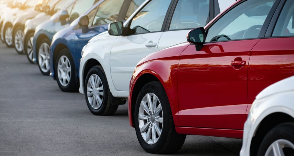 A lineup of new cars with factory tires.