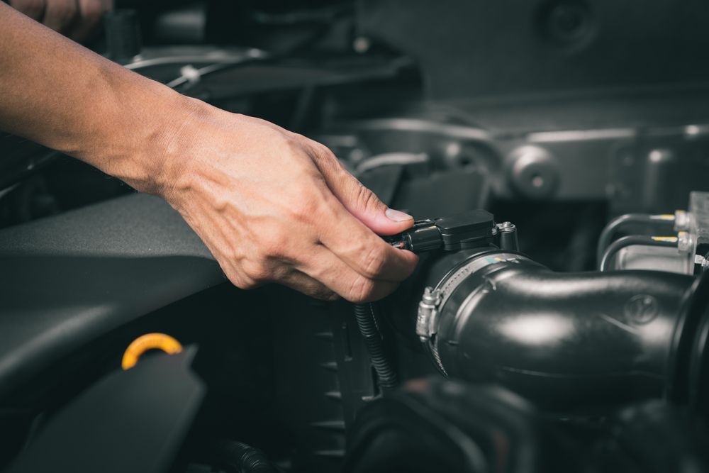 Mechanic unplugging a mass air flow (MAF) Sensor