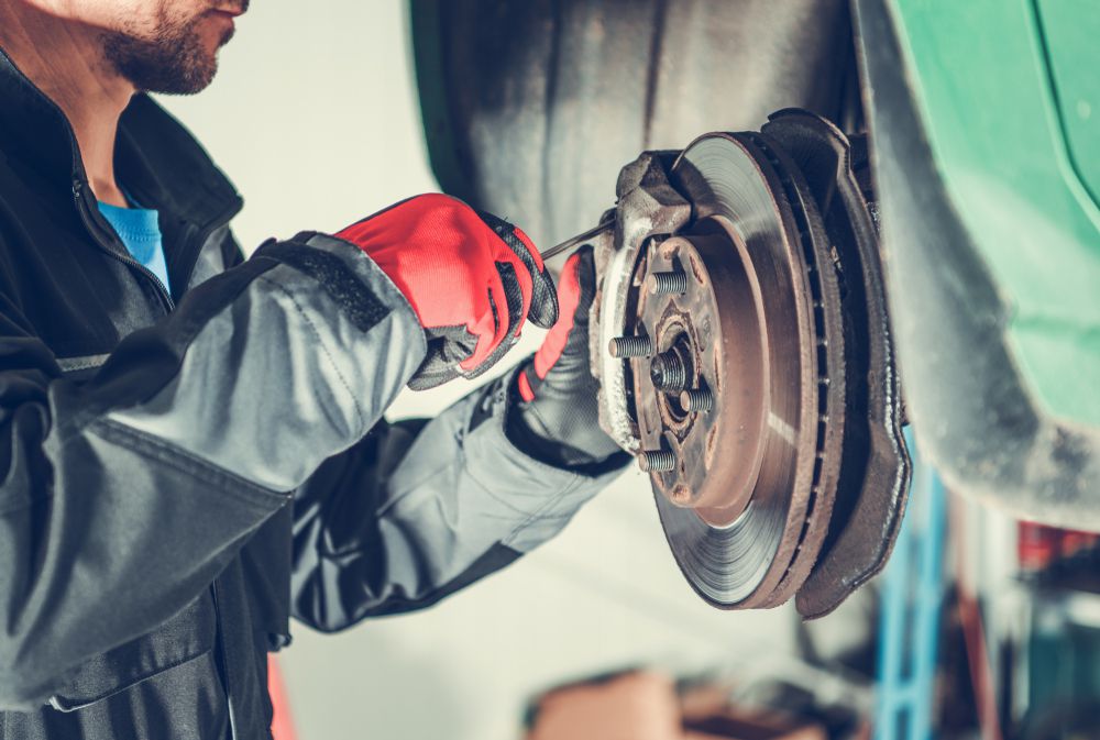 Mechanic changing a brake pad.