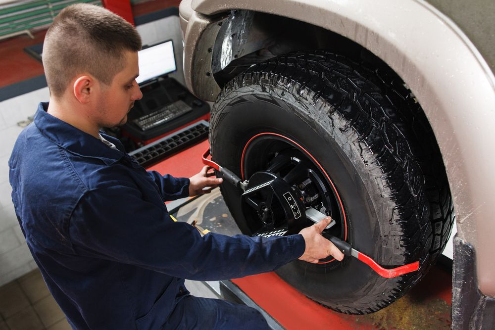 Mechanic checking the alignment of a tire