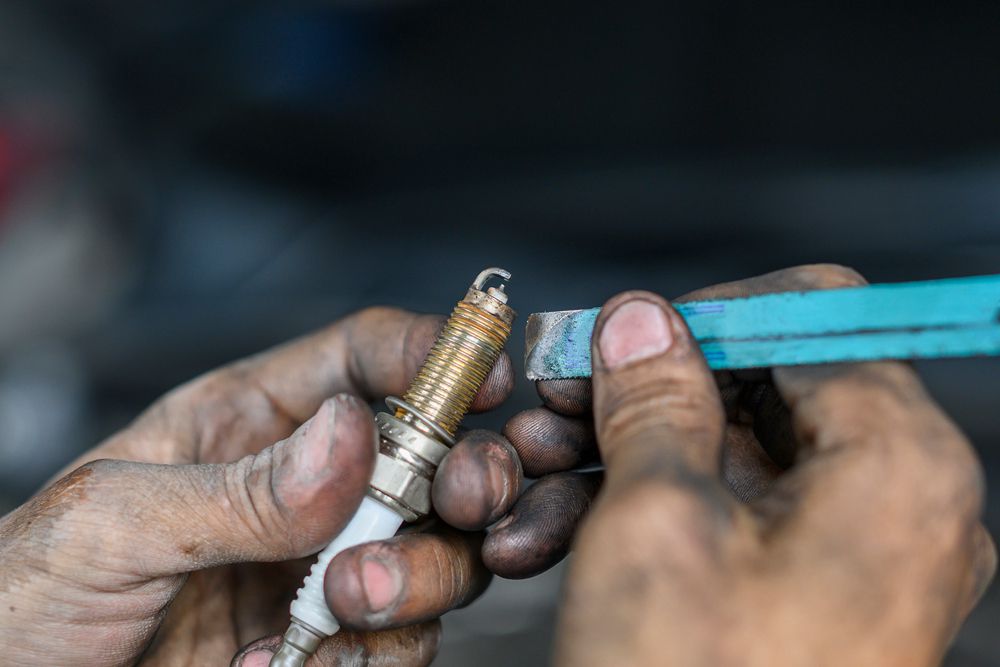 Mechanic checks and cleans spark plug