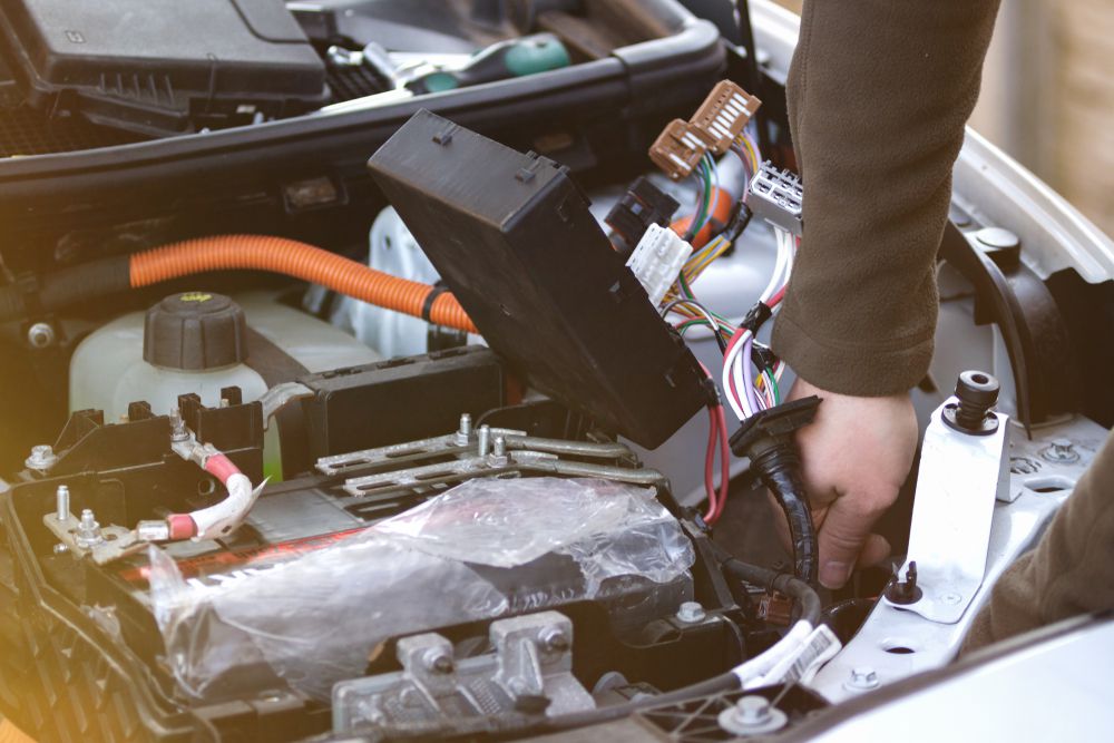 Mechanic installing a fuse box kill switch