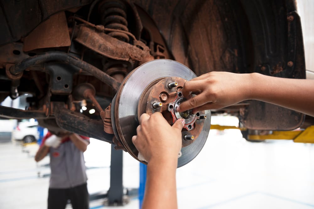 A mechanic installing a new wheel bearing.