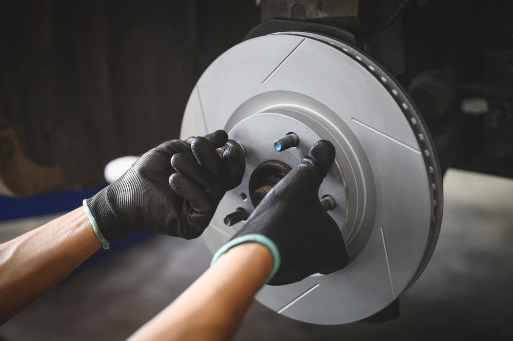 Mechanic installing a brake rotor.