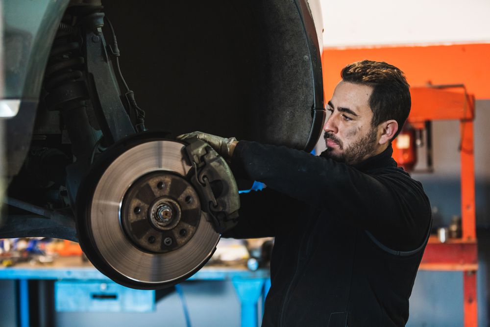 Mechanic installing new brake pads.