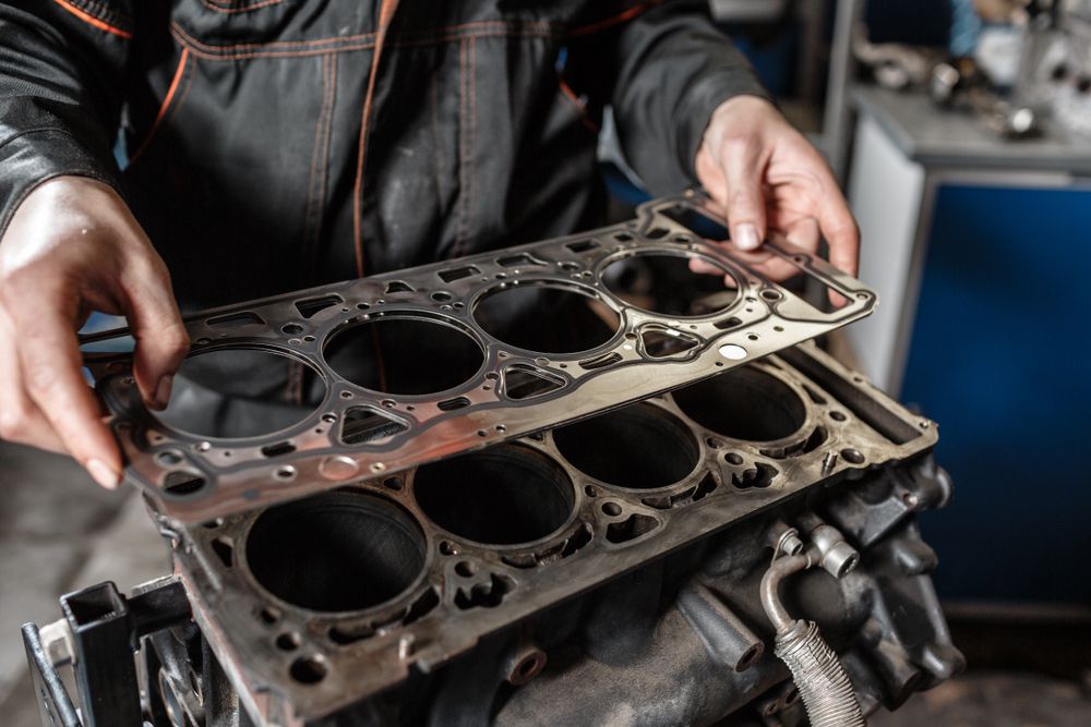 A mechanic installing a new head gasket.