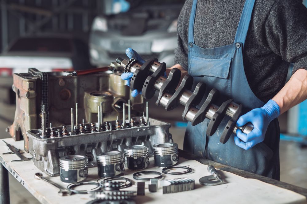 Mechanic preparing parts to build engine