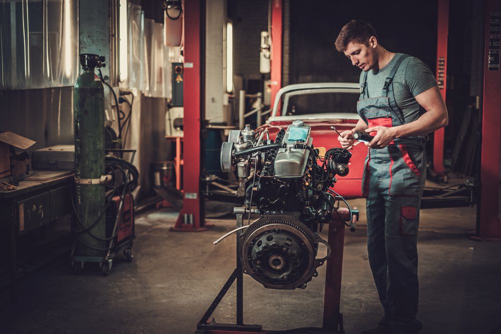 A mechanic rebuilding an engine.