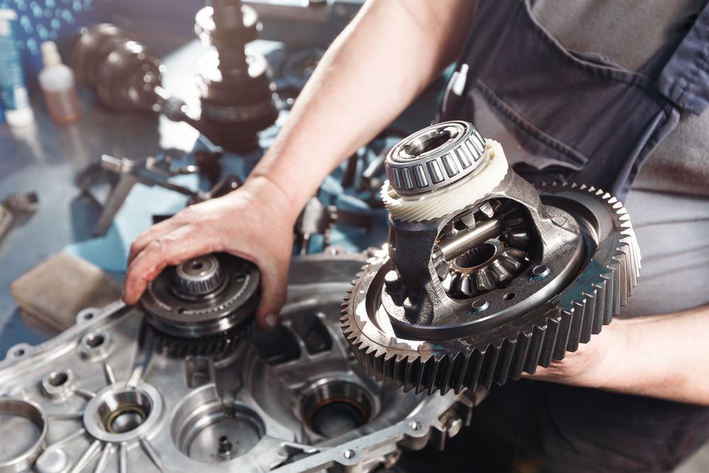 A mechanic rebuilding a transmission.