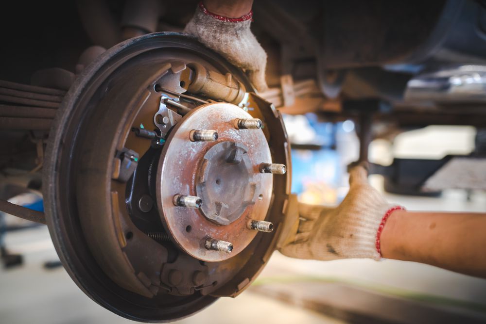 A mechanic removing a brake drum.