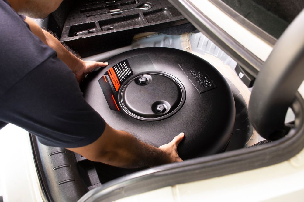 Mechanic removing a gas tank to remove salt.