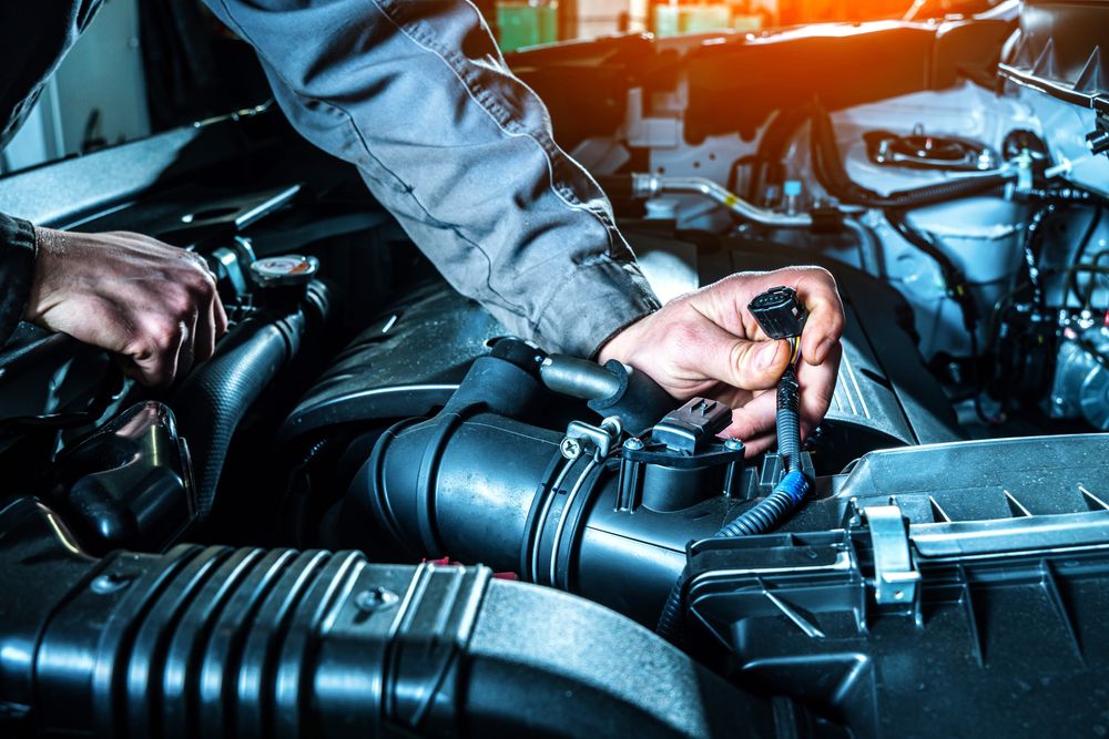 Mechanic replacing MAP sensor in a car