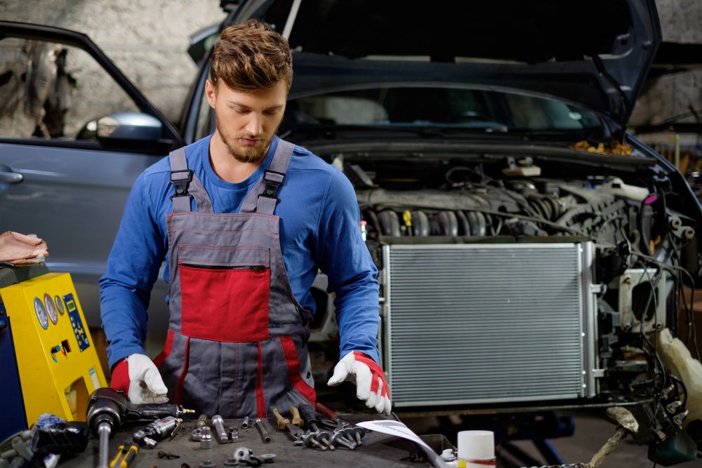 A mechanic repairing a cooling system.