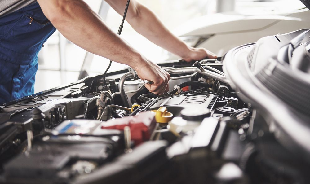 Mechanic working on car engine