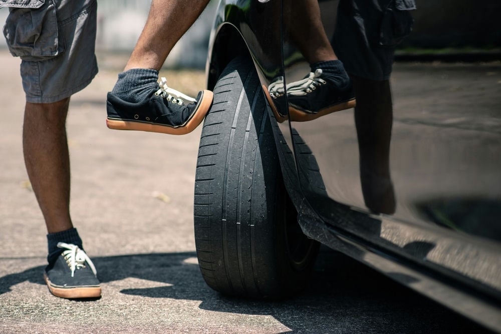 A new car with worn factory tires.