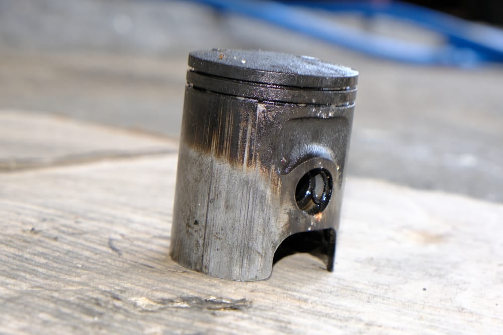 A piston with extreme wear.