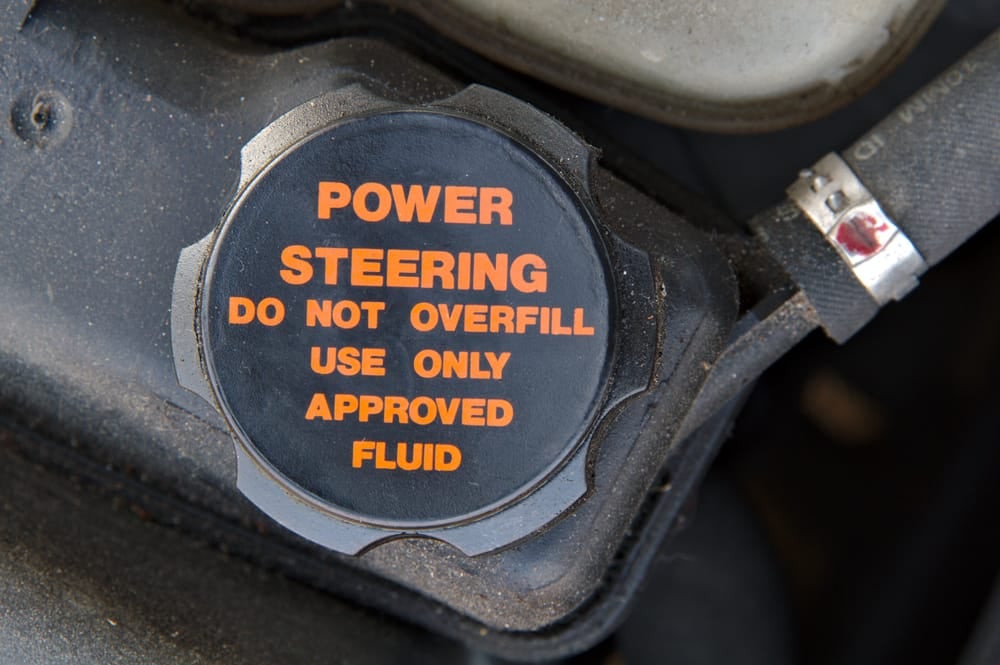 A power steering reservoir almost always has min and max lines to indicate the required fluid level.