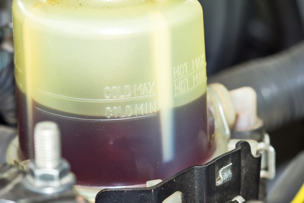 A power steering reservoir almost always has min and max lines to indicate the required fluid level.