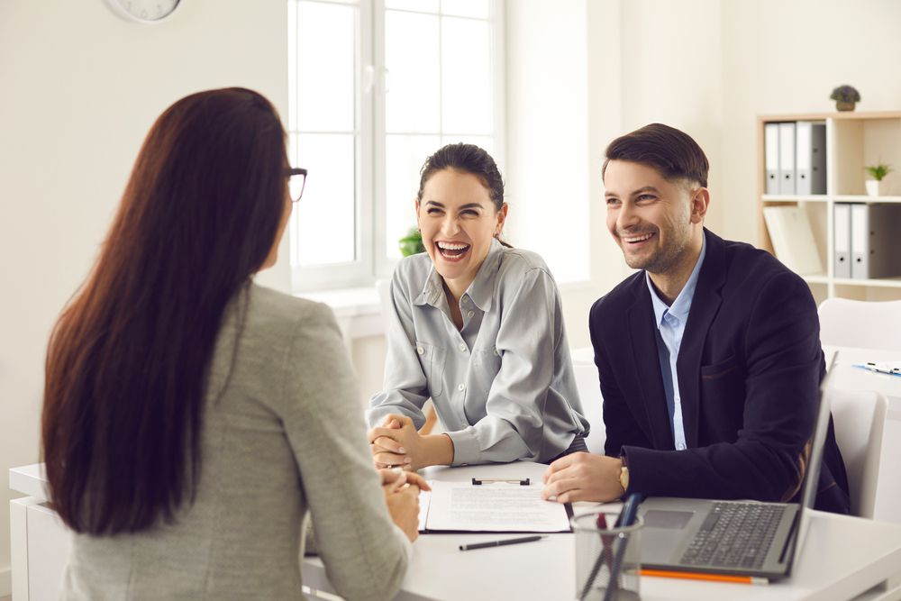 A couple refinancing their car loan at a bank.