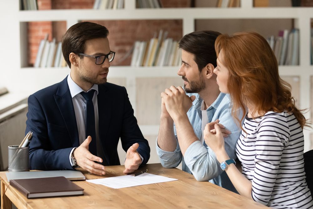 A couple refinancing their car loan at a bank.