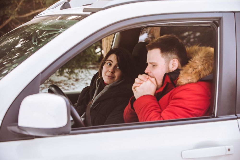 Two people sitting in a cold car.
