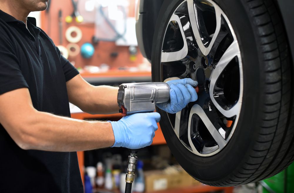 A technicion installing a brand new tire.