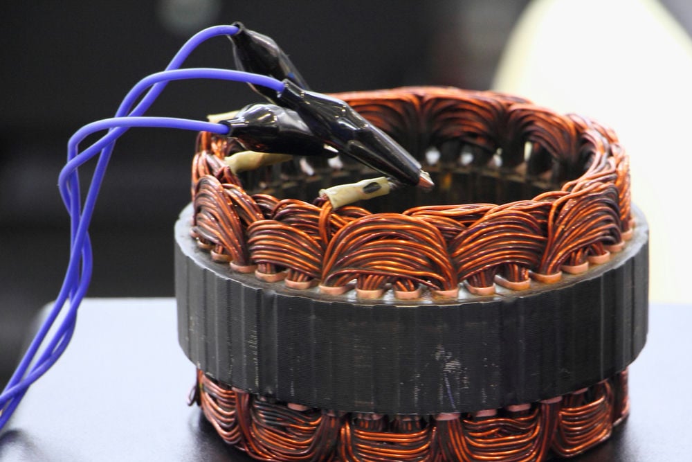 A mechanic testing an alternator.