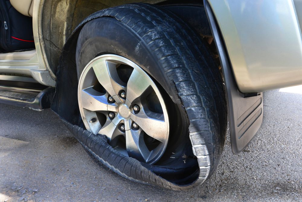 A tire blowout as a result of low tire pressure.