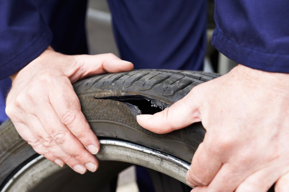 A tire failure as a result of low tire pressure.