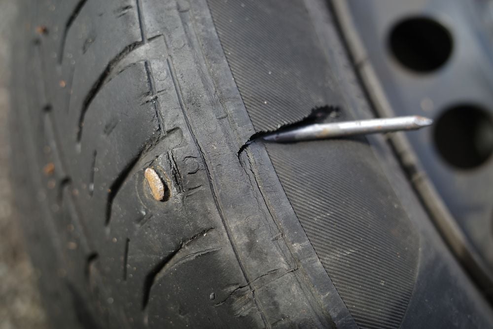 A tire that is not repairable due to a nail through the sidewall.