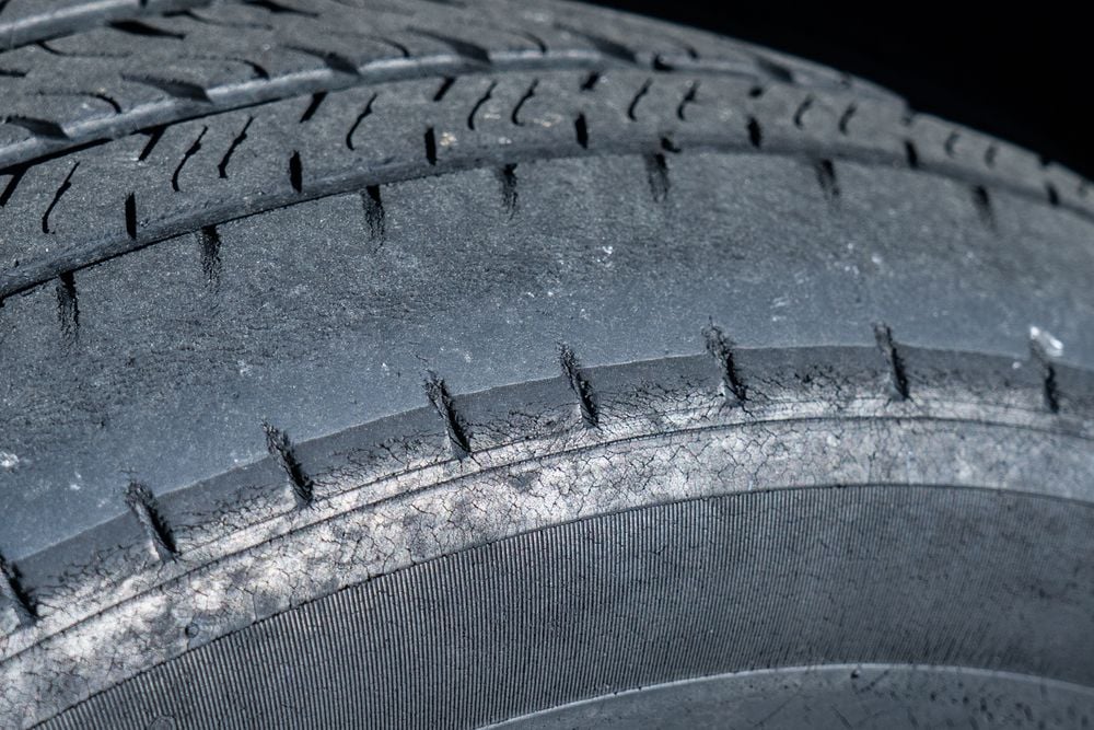 A tire showing an uneven wear pattern.