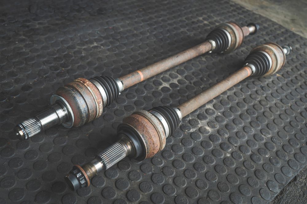 Two CV axles on the shop floor.