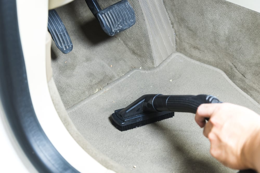 Vacuuming a wet car floor.