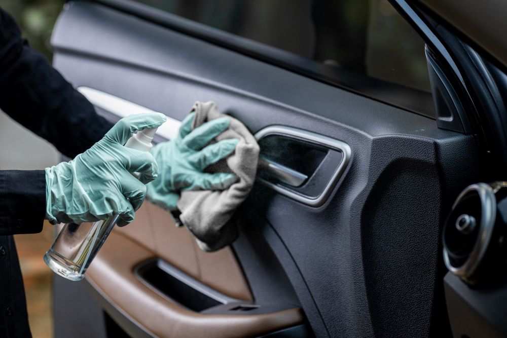 Wiping down the interior of a car ie. Giving the car a little TLC.