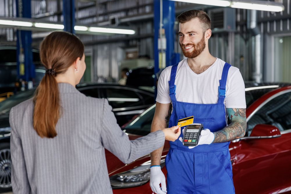 A customer paying her mechanic.